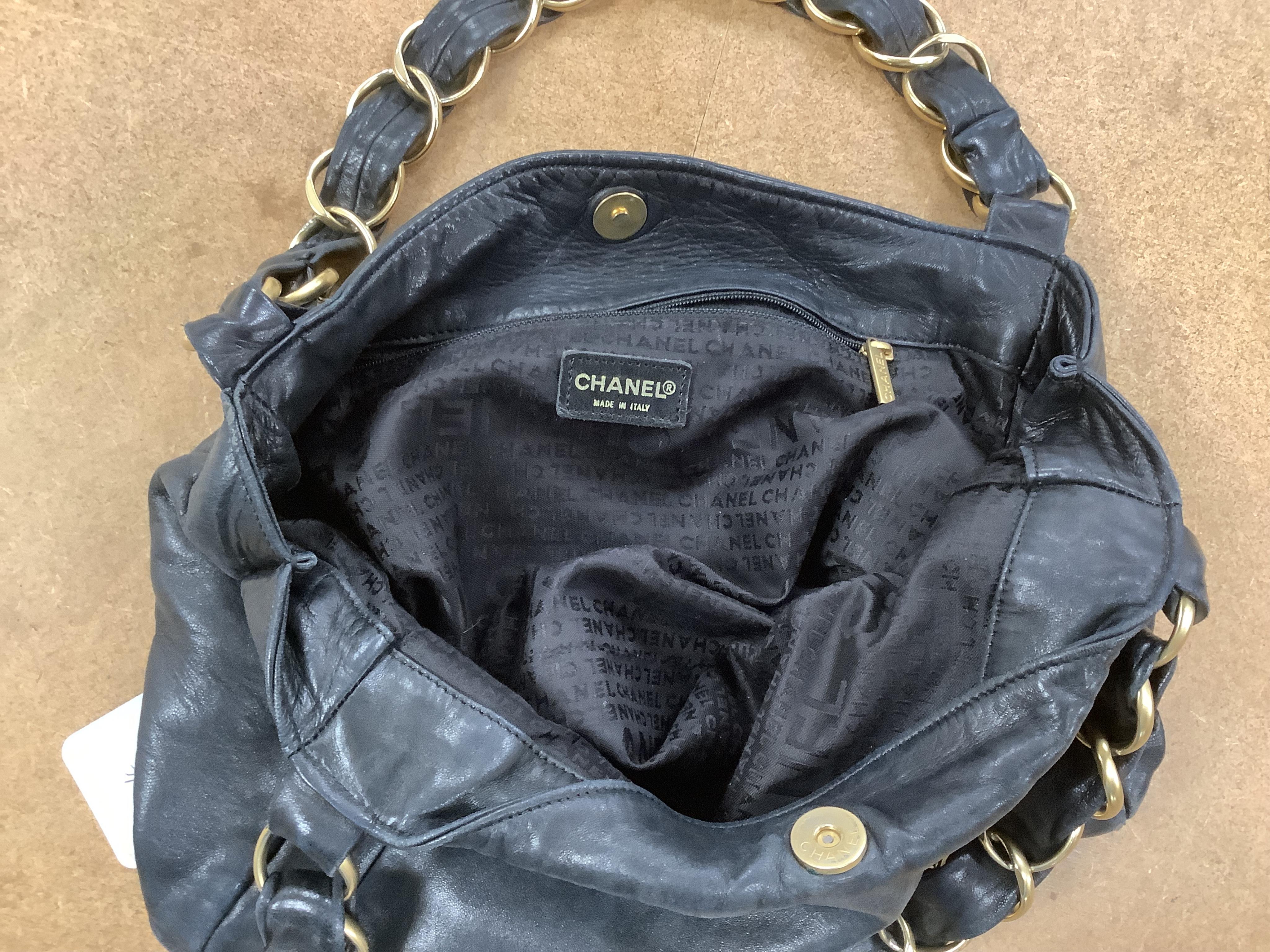 An early 2000’s Chanel black leather handbag with gold hardware, date code 7949937, 31cm wide